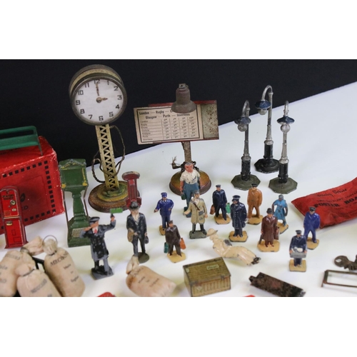 132 - Large group of O gauge station & trackside accessories containing many scare items to include 7 x ti... 