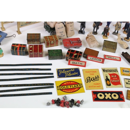 132 - Large group of O gauge station & trackside accessories containing many scare items to include 7 x ti... 