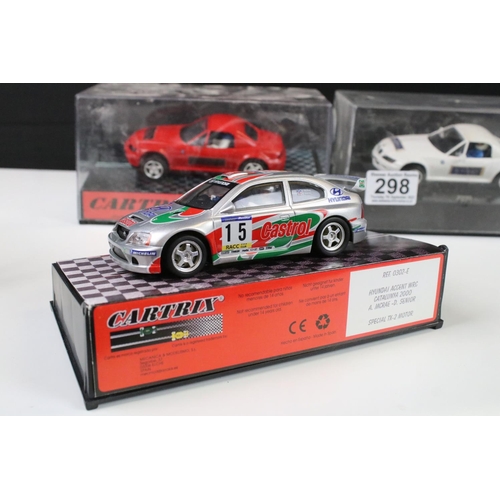 298 - Three cased Cartrix slot cars to include a BMW Z3, 0302-E Hyundai Accent WRC Catalunya 2000 and a 01... 