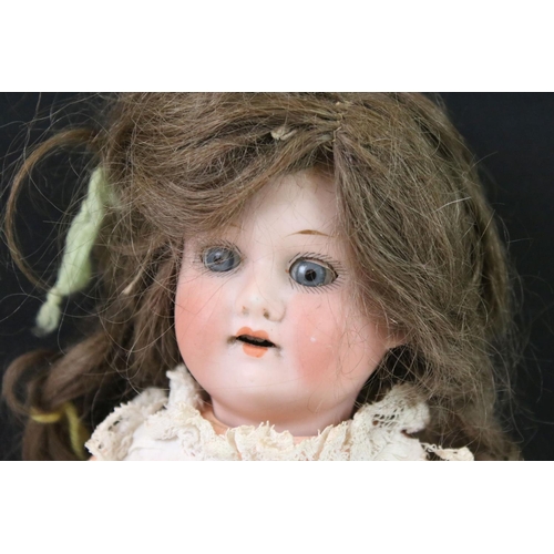 409 - Armand Marseille Bisque Head Doll, impressed mark A 5/0 M, 30cm long together with another small Bis... 