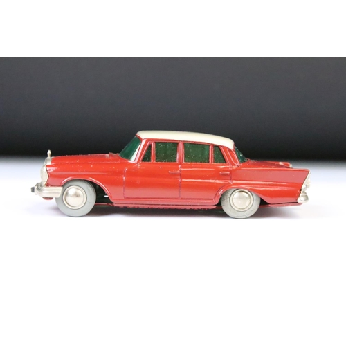 1365 - Boxed clockwork Schuco 1038 Mercedes 220S Micro Racer diecast model in red with white roof, with key... 