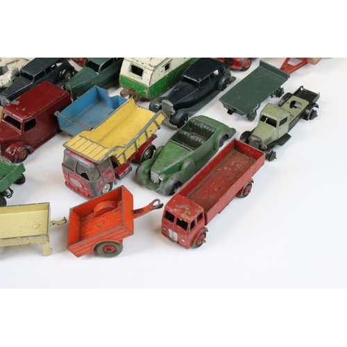 1293 - Around 45 mid 20th C. play worn Dinky diecast models to include a 162 Ford Zephyr, 157 Jaguar, Ford ... 