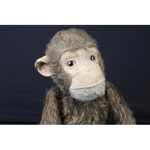 429 - Mid 20th C straw-filled mechanical monkey, jointed, approx 34cm high