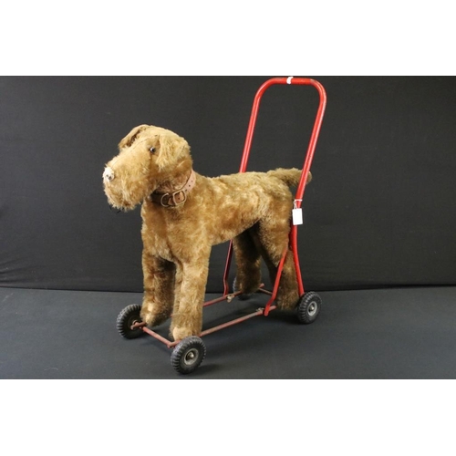 377 - Mid 20th C Triang straw-filled mohair push-along dog toy; together with a Triang Minic wooden car ga... 