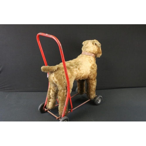 377 - Mid 20th C Triang straw-filled mohair push-along dog toy; together with a Triang Minic wooden car ga... 