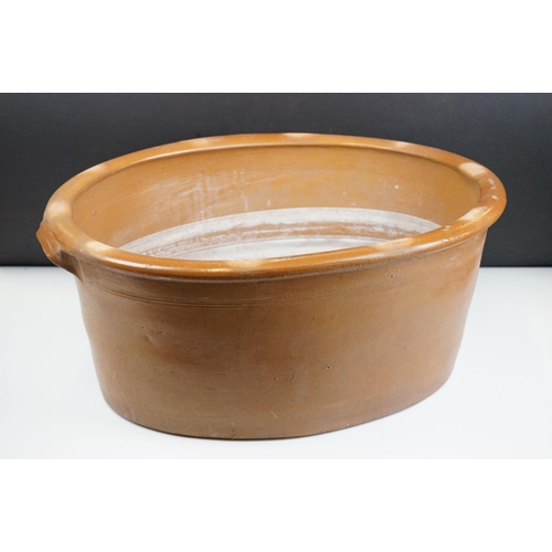 108 - Large 19th Century Victorian salt glazed Dairy Bowl of oval form with twin handles. Measures 23 x 54... 