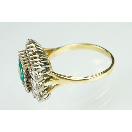 10 - Emerald and diamond 18ct yellow and white gold cluster ring, the central emerald cut emerald measuri... 