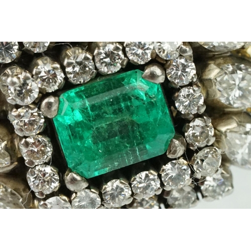 10 - Emerald and diamond 18ct yellow and white gold cluster ring, the central emerald cut emerald measuri... 