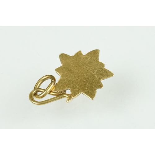 105 - 9ct yellow gold dolphin charm; a yellow metal ladder charm indistinctly stamped 750; and an enamelle... 