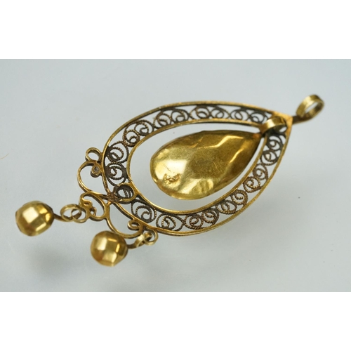 108 - 19th century yellow metal filigree pendant, openwork filigree surround, oval faceted dropper, two ci... 