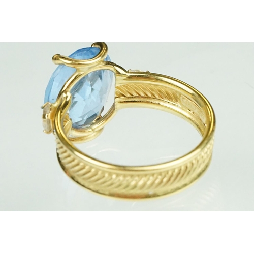 111 - Blue topaz and white stone ring, the band stamped 750, textured band, ring size K½