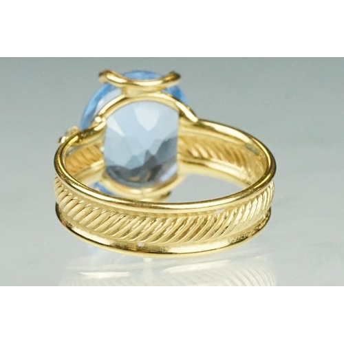 111 - Blue topaz and white stone ring, the band stamped 750, textured band, ring size K½