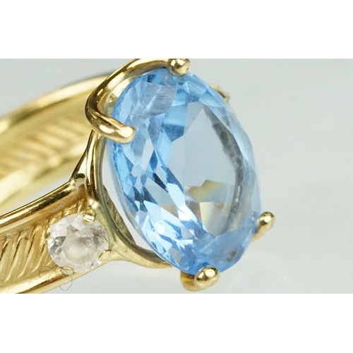 111 - Blue topaz and white stone ring, the band stamped 750, textured band, ring size K½