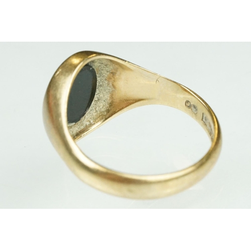 120 - Onyx 9ct yellow gold signet ring, plain polished oval cabochon panel, dimensions approx 11mm x 9mm, ... 