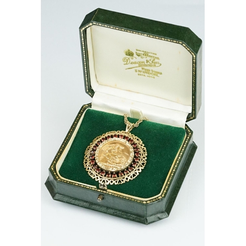 13 - Queen Elizabeth II full sovereign coin pendant necklace, the coin dated 1974, garnet surround, 9ct g... 