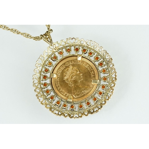 13 - Queen Elizabeth II full sovereign coin pendant necklace, the coin dated 1974, garnet surround, 9ct g... 