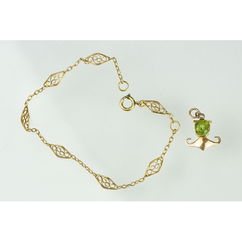 144 - Edwardian 15ct gold peridot and pearl pendant together with a yellow metal filigree bracelet with sp... 