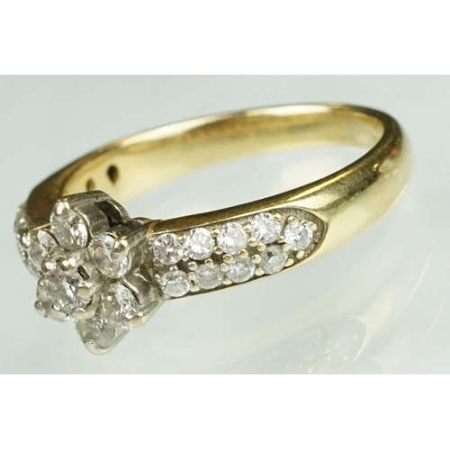 17 - Diamond flower head 18ct yellow gold ring, the centre round brilliant cut diamond weighing approx 0.... 