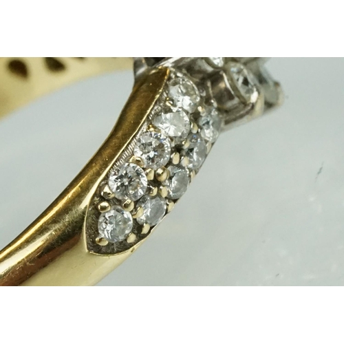 17 - Diamond flower head 18ct yellow gold ring, the centre round brilliant cut diamond weighing approx 0.... 