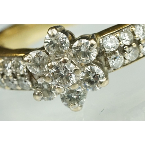 17 - Diamond flower head 18ct yellow gold ring, the centre round brilliant cut diamond weighing approx 0.... 