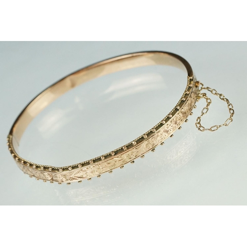 173 - Rose gold hinged bangle, the upper half with floral and foliate scroll decoration, bead detailing, t... 