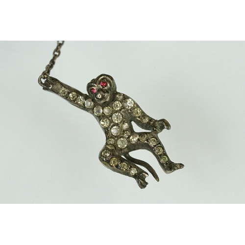 21 - 19th century paste silver brooch modelled as a monkey on a trapeze bar, suspending another monkey, f... 