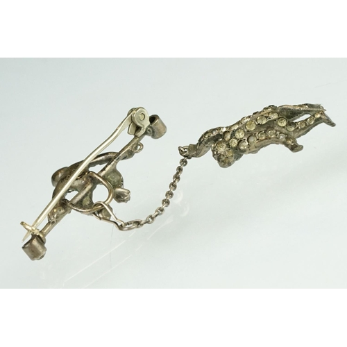 21 - 19th century paste silver brooch modelled as a monkey on a trapeze bar, suspending another monkey, f... 