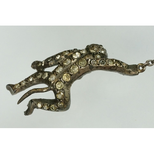 21 - 19th century paste silver brooch modelled as a monkey on a trapeze bar, suspending another monkey, f... 