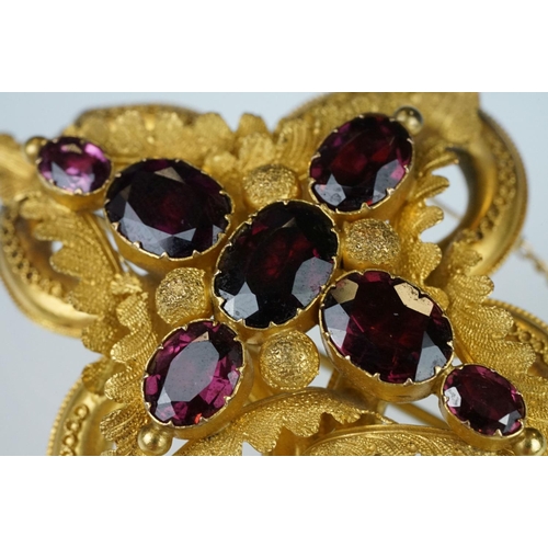 3 - Early Victorian garnet yellow metal brooch, seven graduated oval mixed cut garnets, the largest meas... 