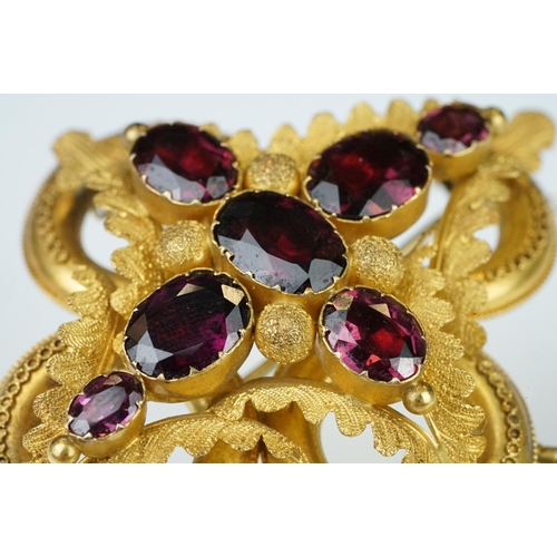 3 - Early Victorian garnet yellow metal brooch, seven graduated oval mixed cut garnets, the largest meas... 