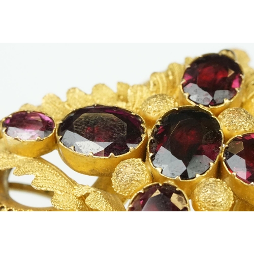 3 - Early Victorian garnet yellow metal brooch, seven graduated oval mixed cut garnets, the largest meas... 