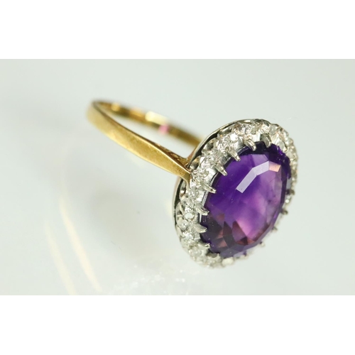 43 - Amethyst and diamond dress ring having a large oval cut amethyst to the centre set with a halo of ro... 