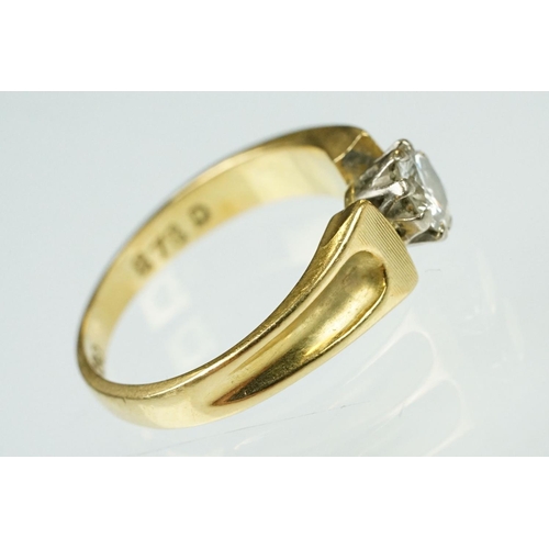 52 - Diamond solitaire 18ct yellow and white gold set ring, the round brilliant cut diamond weighing appr... 