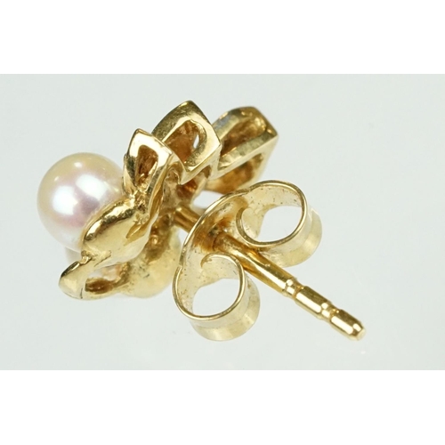 54 - Pair of cultured pearl and diamond yellow metal stud earrings, two cream cultured pearls with pink o... 