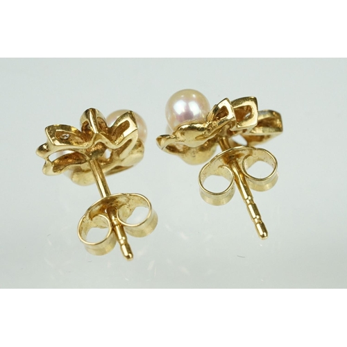 54 - Pair of cultured pearl and diamond yellow metal stud earrings, two cream cultured pearls with pink o... 