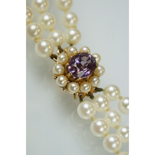 57 - Cultured pearl triple strand necklace with amethyst and pearl 9ct gold clasp, the white cultured pea... 