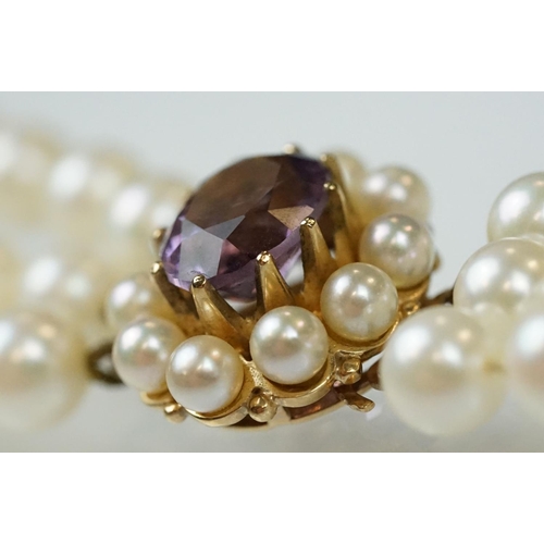 57 - Cultured pearl triple strand necklace with amethyst and pearl 9ct gold clasp, the white cultured pea... 