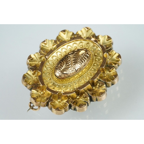 58 - 19th century 9ct gold stepped oval brooch, embossed foliate decoration, bead and rope twist detailin... 