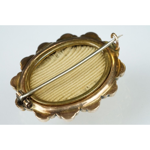 58 - 19th century 9ct gold stepped oval brooch, embossed foliate decoration, bead and rope twist detailin... 