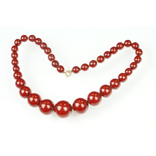 60 - 1930s cherry bakelite beaded necklace having graduating round beads and a spring ring clasp. Measure... 