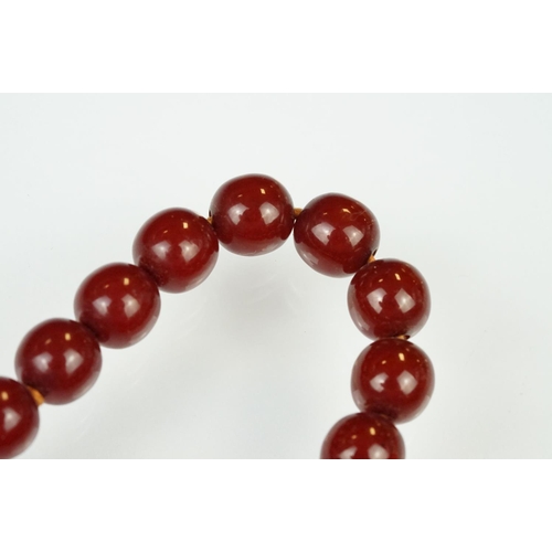 60 - 1930s cherry bakelite beaded necklace having graduating round beads and a spring ring clasp. Measure... 