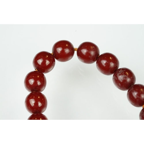 60 - 1930s cherry bakelite beaded necklace having graduating round beads and a spring ring clasp. Measure... 