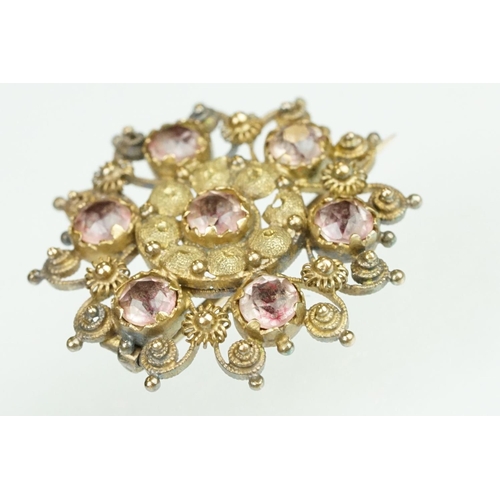 61 - 19th Century yellow metal cannetille brooch of round design set with seven round cut foil back stone... 