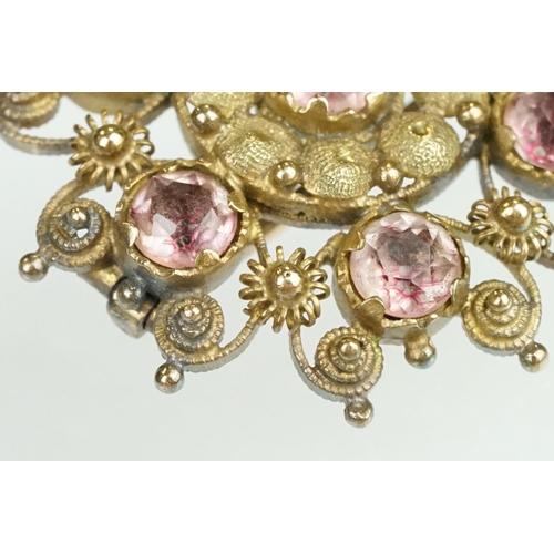 61 - 19th Century yellow metal cannetille brooch of round design set with seven round cut foil back stone... 