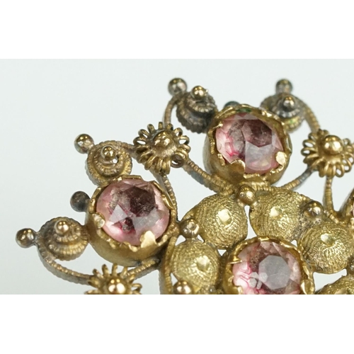 61 - 19th Century yellow metal cannetille brooch of round design set with seven round cut foil back stone... 