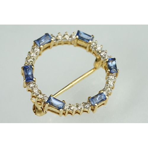 68 - Sapphire and diamond 18ct yellow gold wreath brooch, six baguette cut sapphires, dimensions approx 2... 