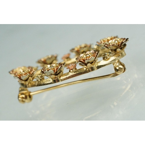 77 - 9ct yellow and rose gold oval brooch, flower head design, dimensions approx 2.5cm x 3.5cm