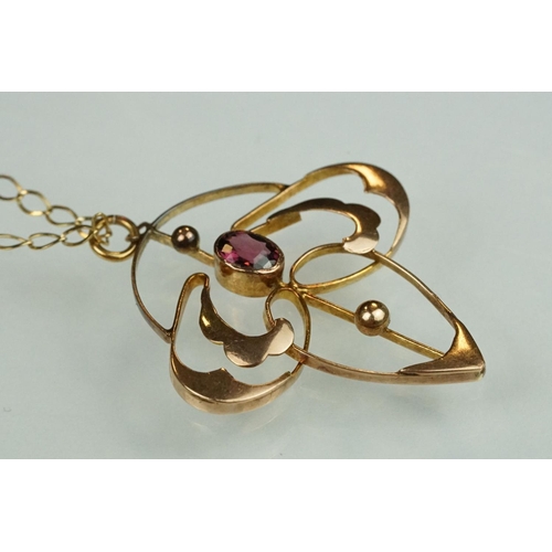 82 - Art Nouveau garnet 9ct rose gold pendant, the oval mixed cut garnet measuring approx 4.5mm x 3.5mm, ... 