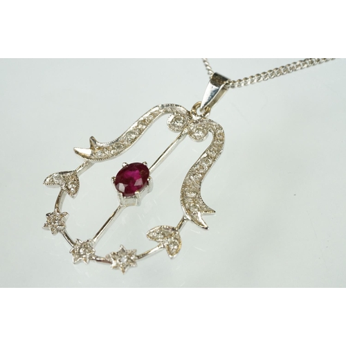 83 - Ruby and diamond 18ct white gold pendant necklace, the central oval mixed cut ruby measuring approx ... 