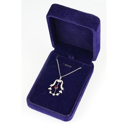 83 - Ruby and diamond 18ct white gold pendant necklace, the central oval mixed cut ruby measuring approx ... 